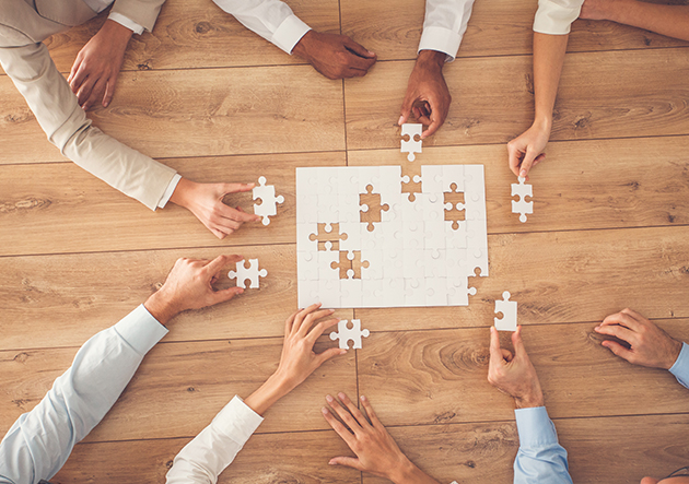 Group of people around a puzzle